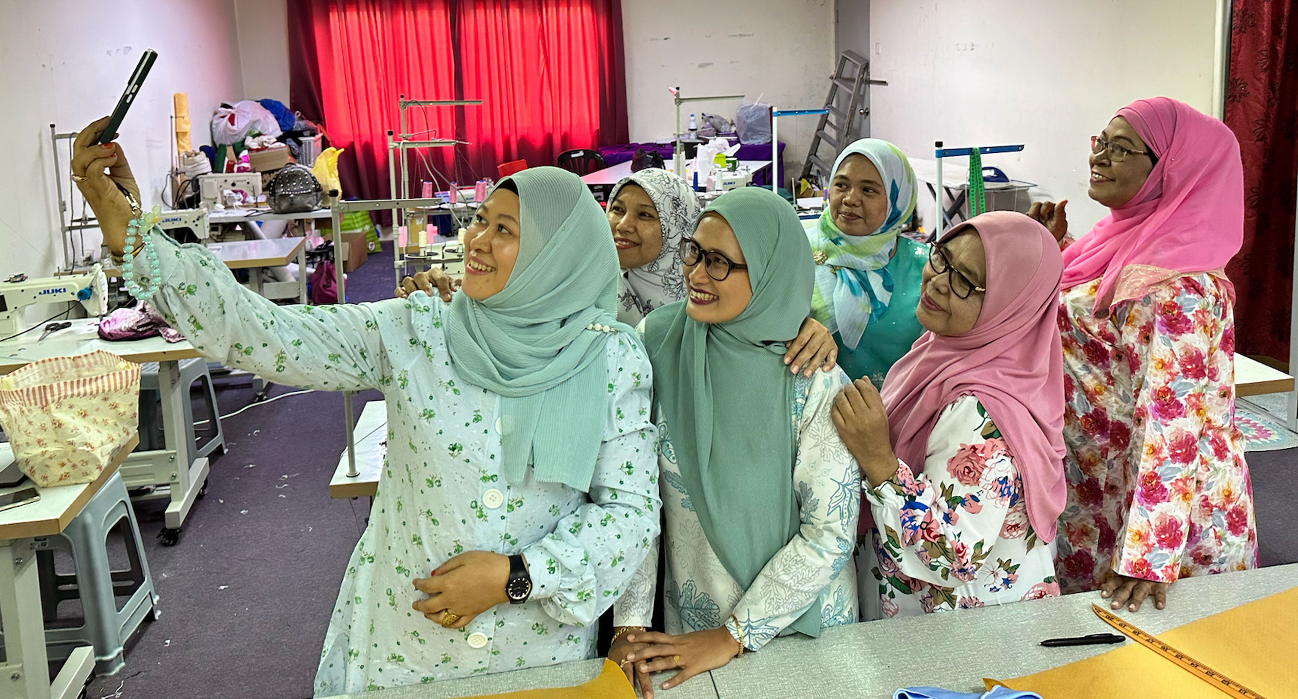 Kak Misha with fellow women entrepreneurs at WOW’s Community Sewing Centre