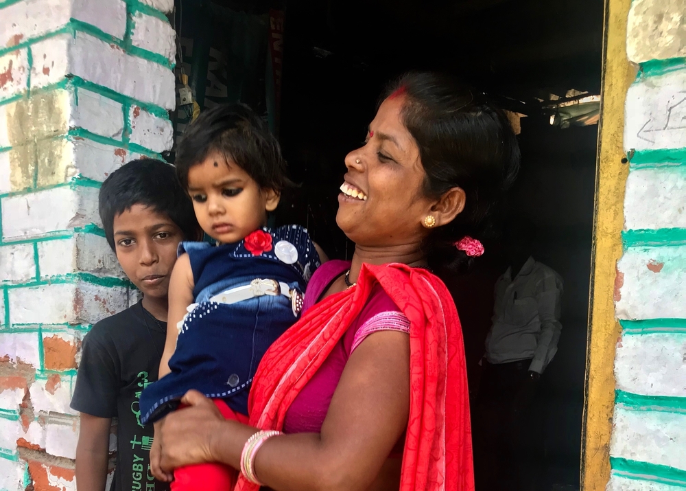 Ranjana, who was featured in our original story, with her children outside her house in Kanpur.