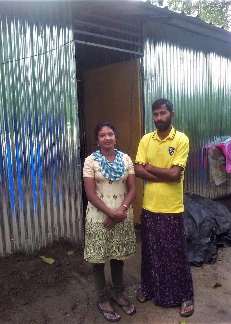 The house of Smitha and her husband A Ramesh (left) was so badly damaged during the floods that they had to put up plastic sheets for walls in the aftermath. With the help of SaveAGram, they built a new home with tin walls. Photo courtesy of SaveAGram