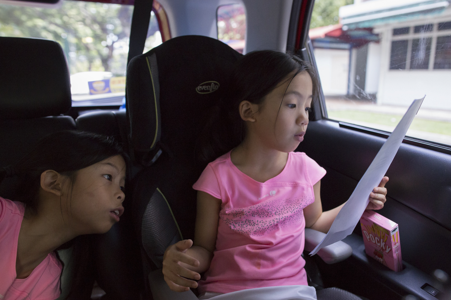 After packing meals, the girls head off in their mother’s car to deliver food personally to meal recipients. Angie helps direct her mother as she reads out a list of addresses.