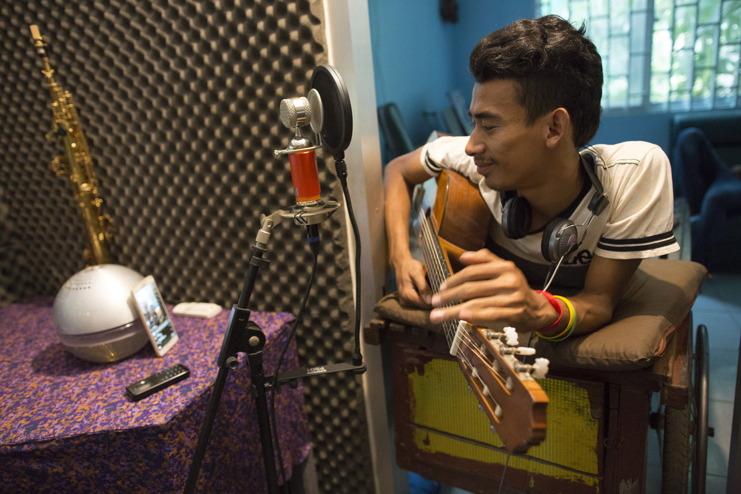 Sophanna recording an original song at a friend’s studio. He has over 45,800 followers on his Facebook page, PhannaUseal, where he posts regular updates on his music.