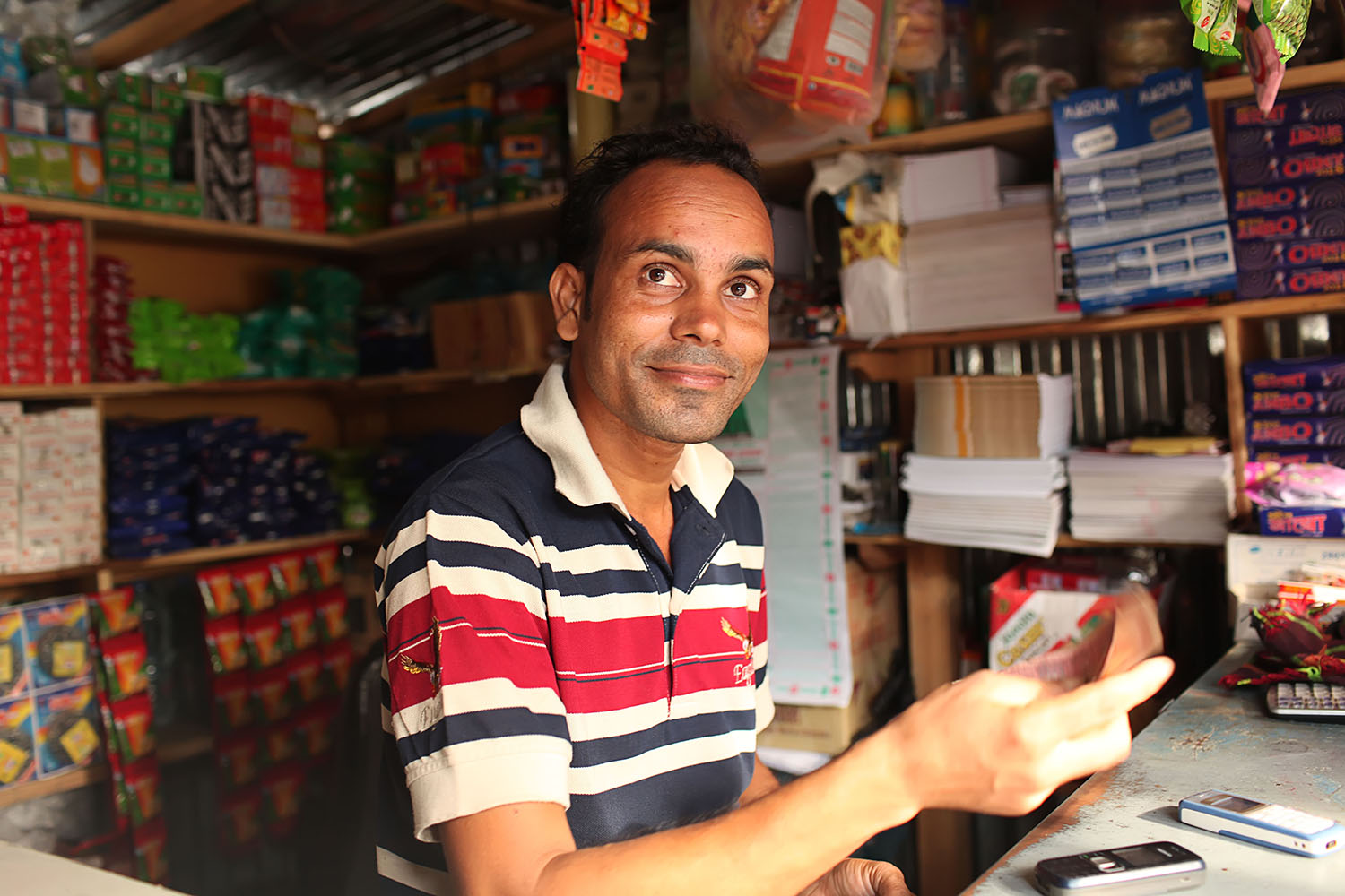This is Shahin, who is back home with his family and has set up a provisions shop, having left Singapore for good