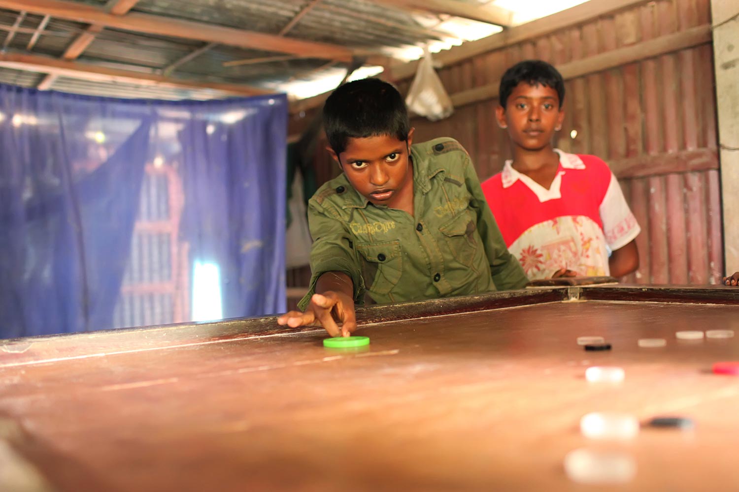 Saiful's brother plays carom at the same shop Saiful used to spend hours after school. Saiful wears the same steely gaze as his brother during the intense carom skirmishes in Singapore's Little India
