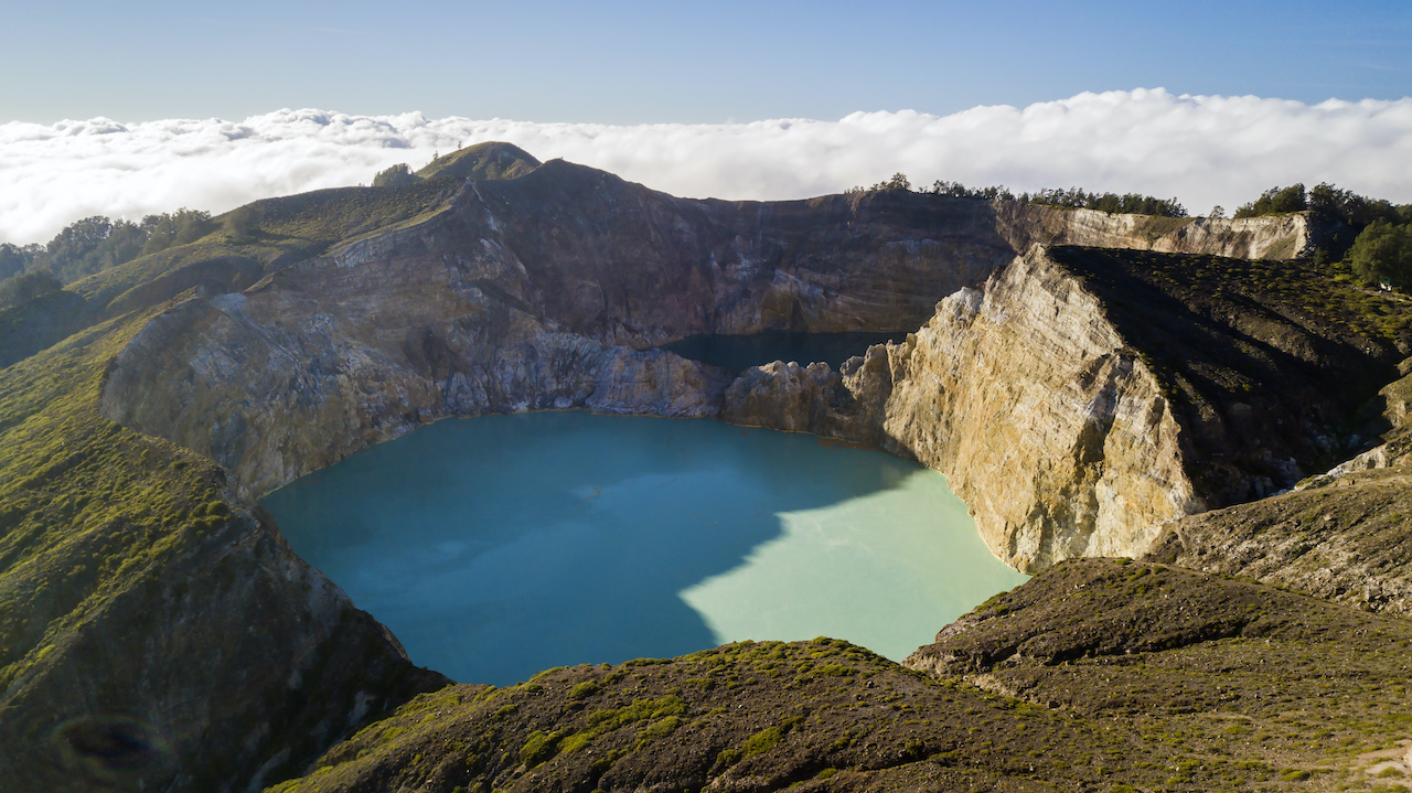 Two of the Mount Kelimutu’s Tricolour Lakes: Tiwu Nuwa Muri Ko’o Fai (Lio for “Lake for the Souls of Young Men and Maidens”)in the foreground, and Tiwu Ata Polo (“Lake for the Souls of Malevolent Shamans”) in the background. The lakes are accessible via a 30-minute hike from the entrance gate. Photo by Andra Fembriarto