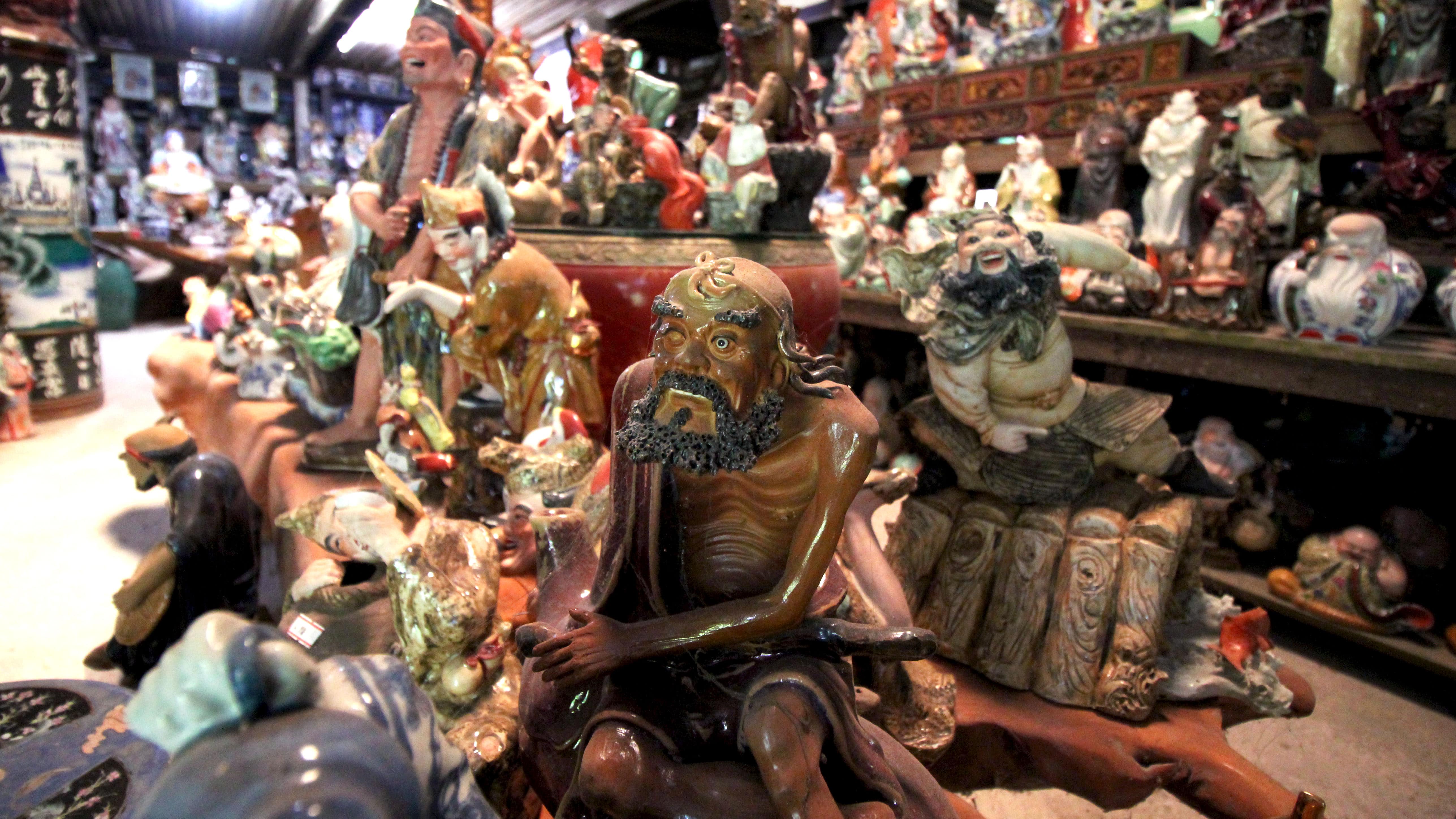 Besides dinnerware like bowls, plates and teapots, Thow Kwang also sells intricately-crafted figurines of Chinese deities and other characters from history and folklore. Photo by Lin Yanqin	