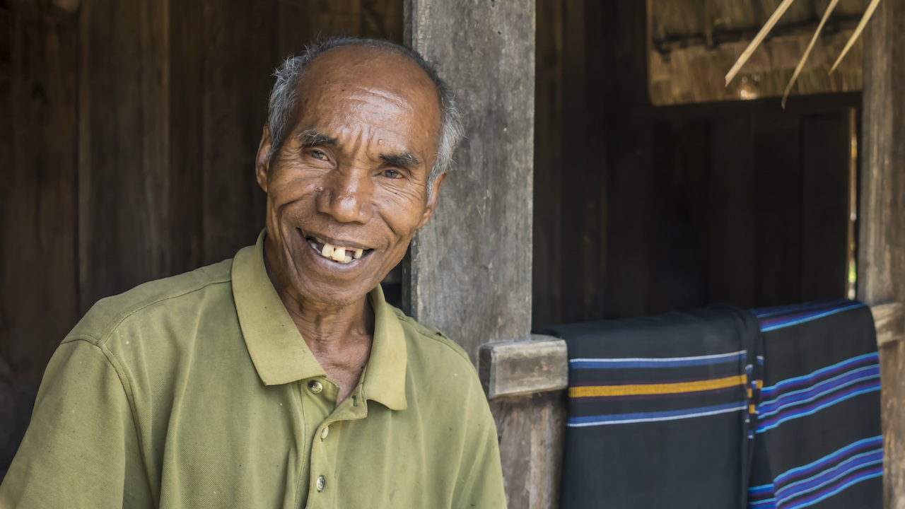 Aloysius Leta, Wologai village elder, has seen four Wologai fires in his lifetime. The last one, in 2012, consumed every single house in Wologai, and the houses seen today are reproductions. Photo by Andra Fembriarto