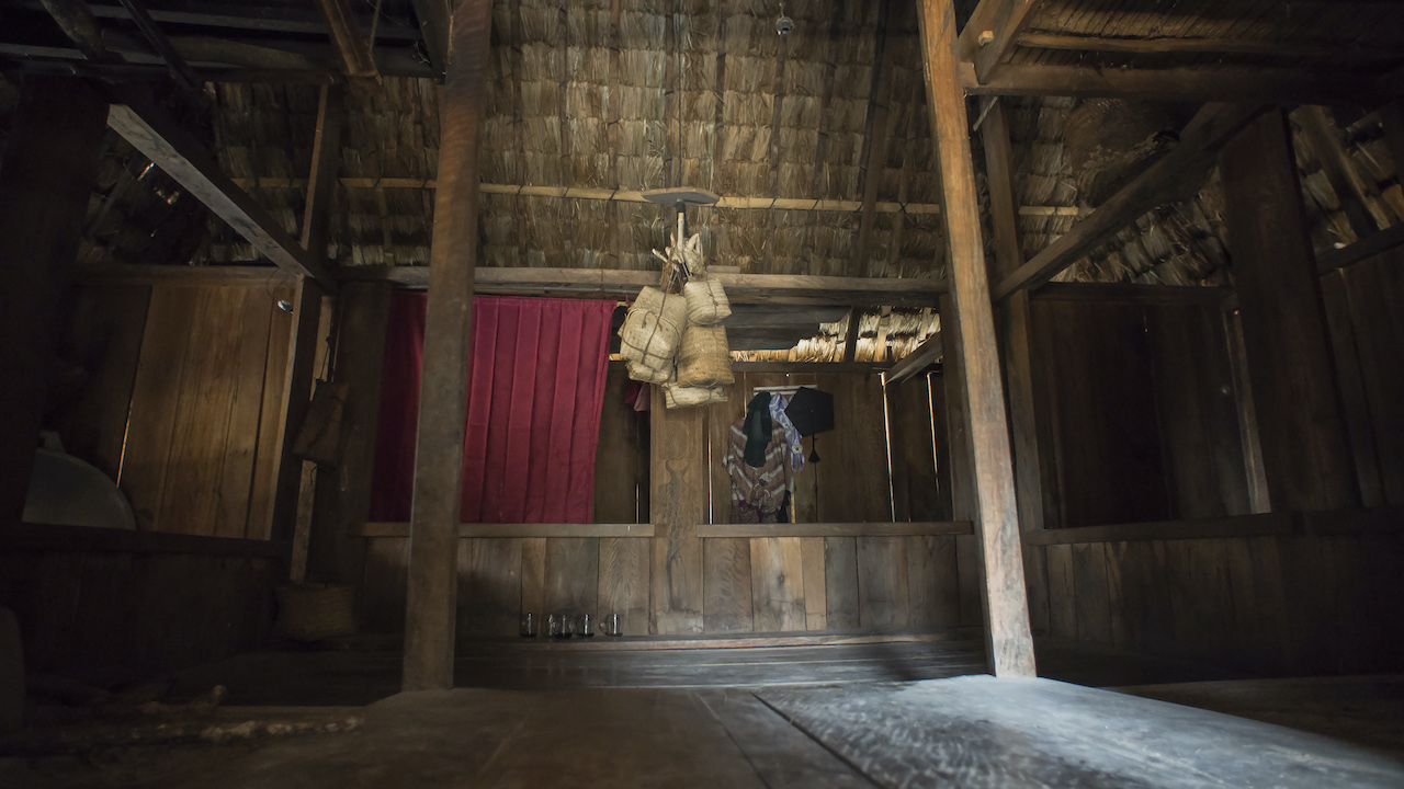 The interior of a traditional Lio house, with partitions for miniature bedrooms and a common area. Lio houses traditionally hang a pair of deer antlers from the ceiling with baskets of sacred white rice, symbolising the milk in a mother’s breasts. Photo by Andra Fembriarto
