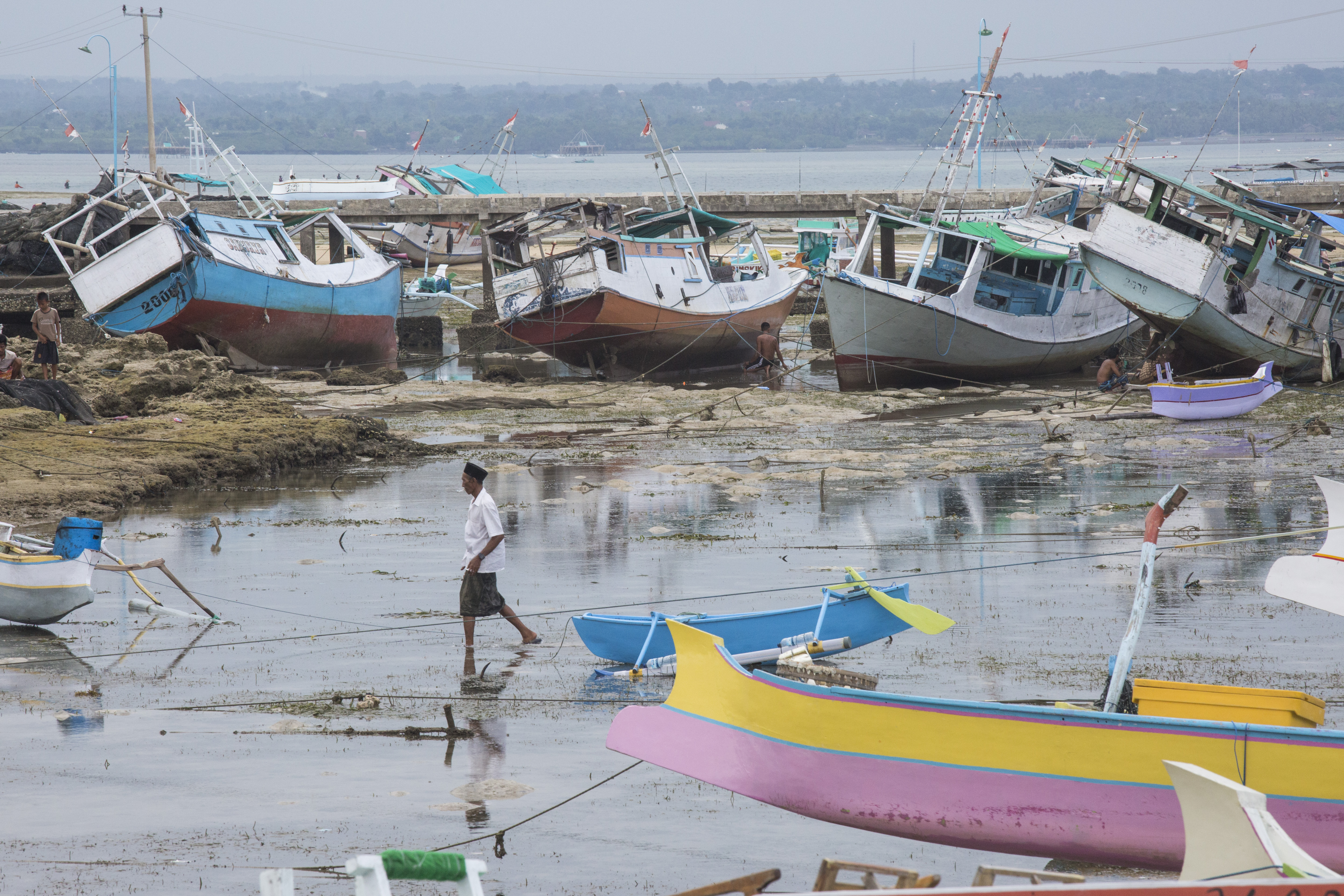 Fishing boats docked at the island jetty where many villagers continue to reply on shark fishing as the main source of income for their families.