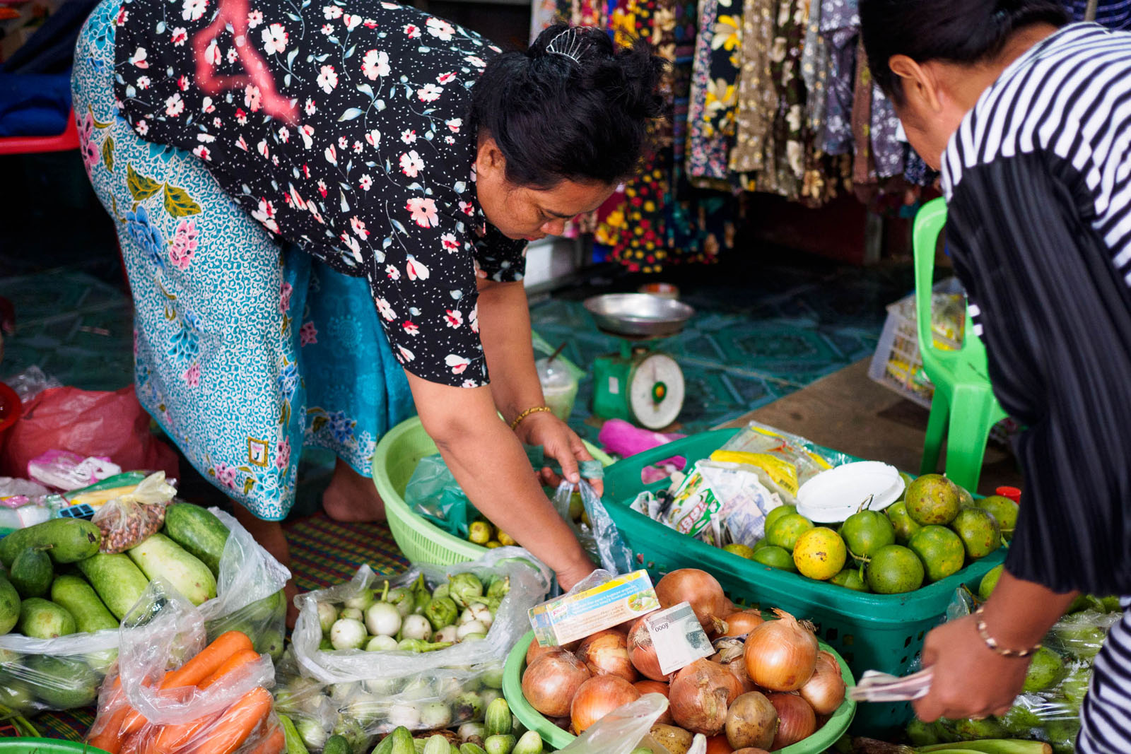 Women sell fruit and vegetables at the local market in Banteay Chhmar. Photo by Emily Lush