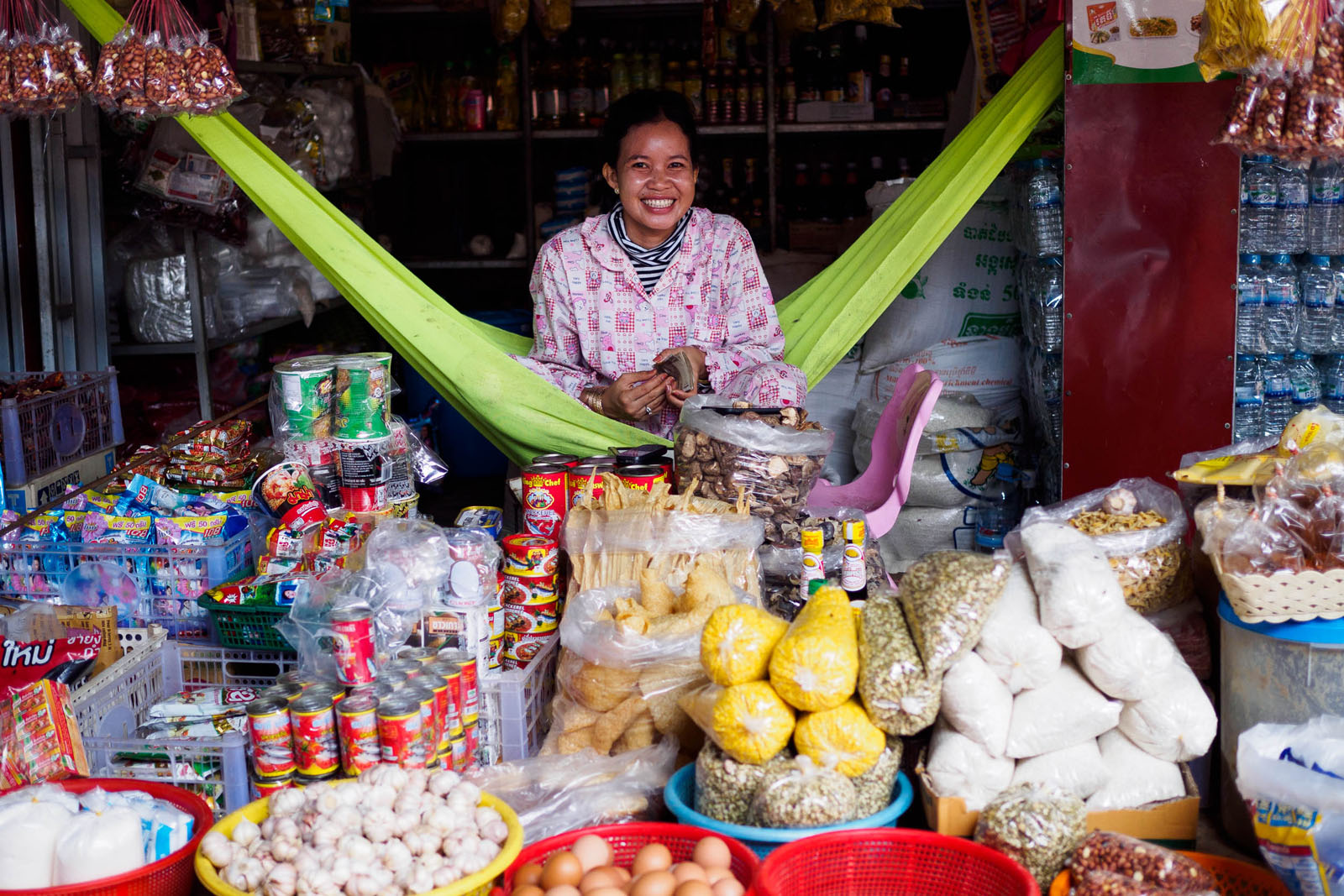 A woman sells packaged food at the local market. Being so close to the Thai border, a lot of goods are imported. Photo by Emily Lush