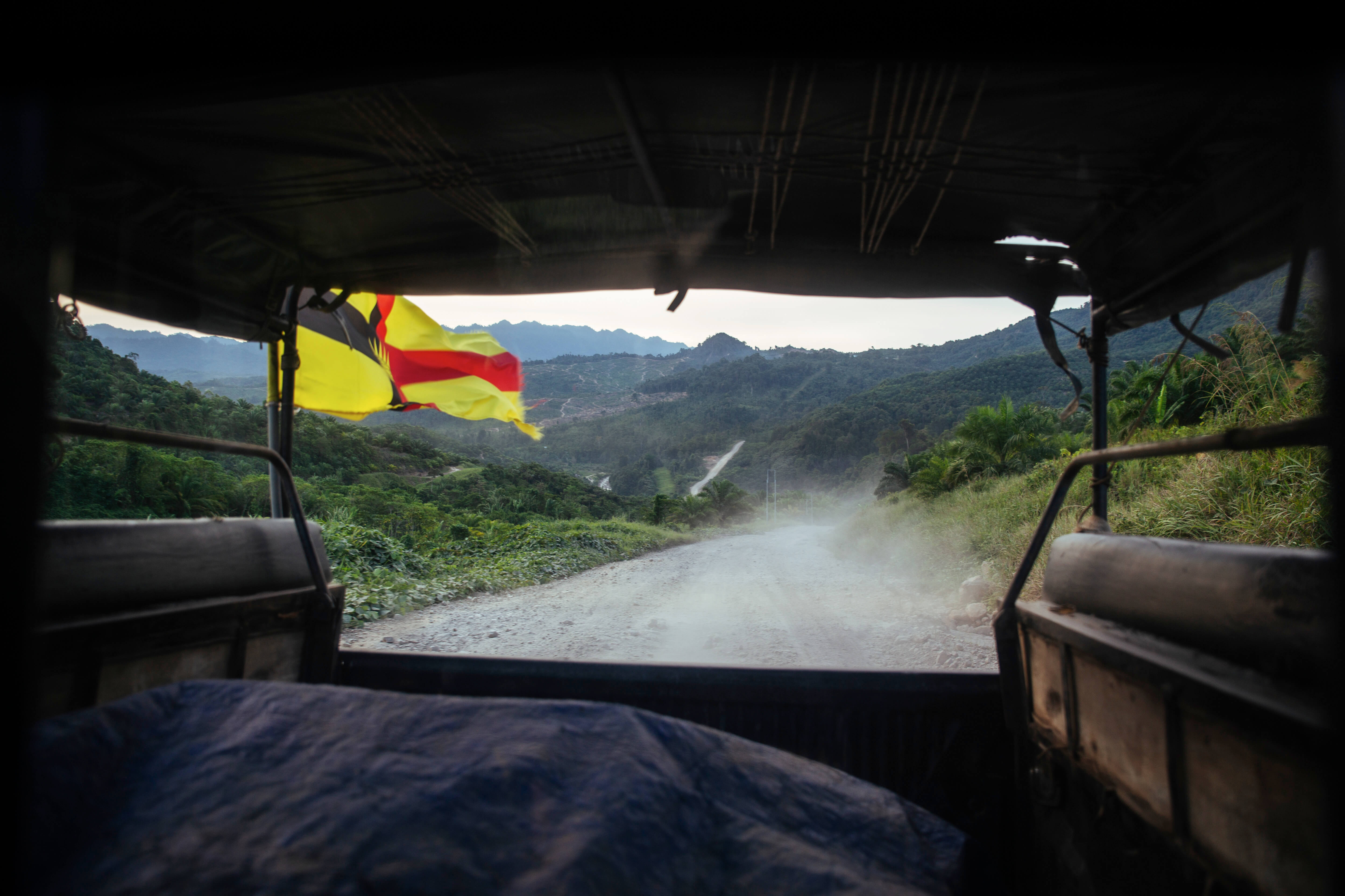 View of the road from the back of a lorry, in Long Semado Valley.