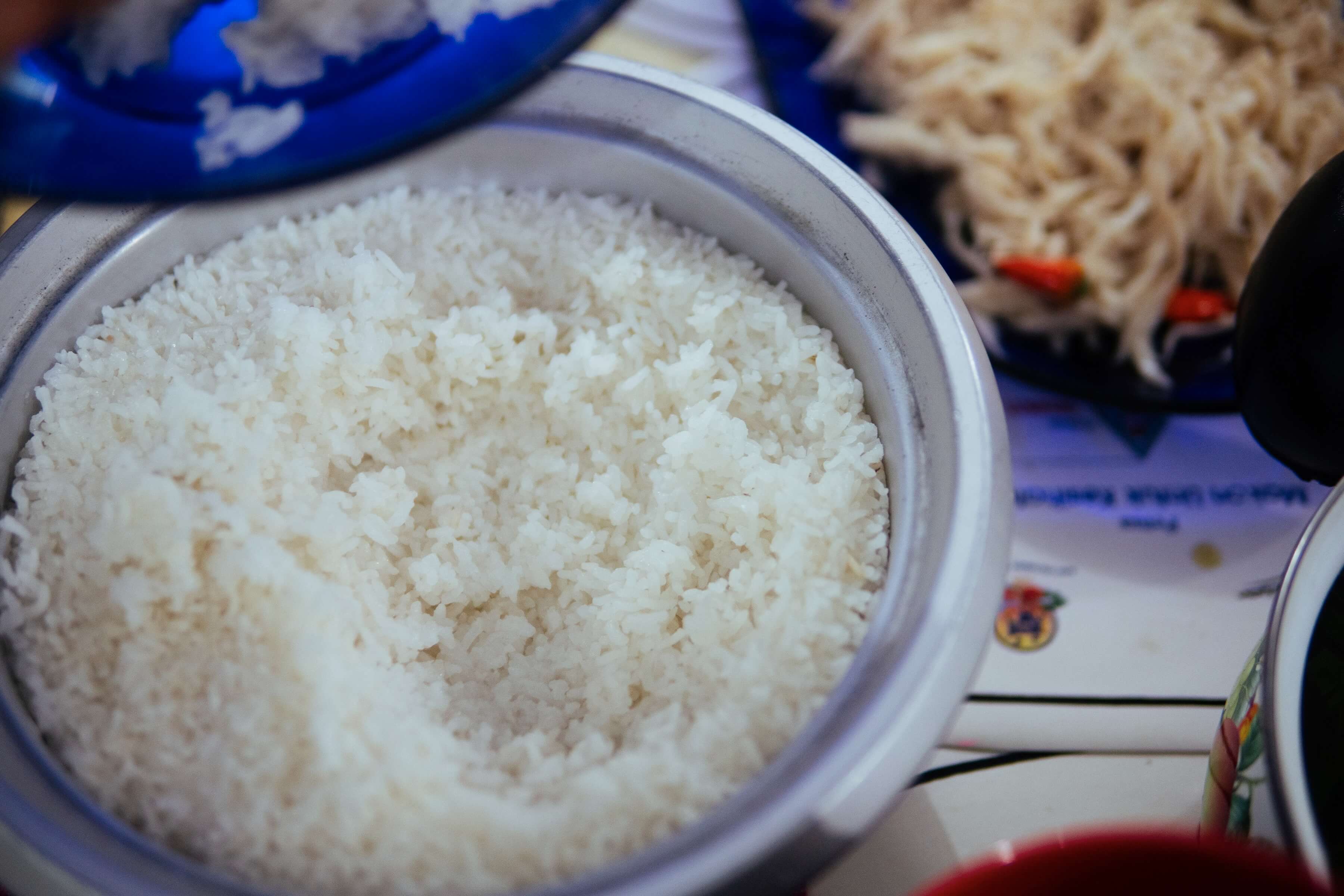 A close-up of a pot of perfectly-cooked white rice, each grain firm and distinct. The star crop is, of course, rice. Farmers like Aunty Ribed once threw away anything they couldn’t eat themselves, as the rice fetched poor prices that barely covered the cost of transport. Now, with Langit paying them fair prices and transporting the produce directly to more lucrative markets, rice has become a crop that nourishes farmers financially too