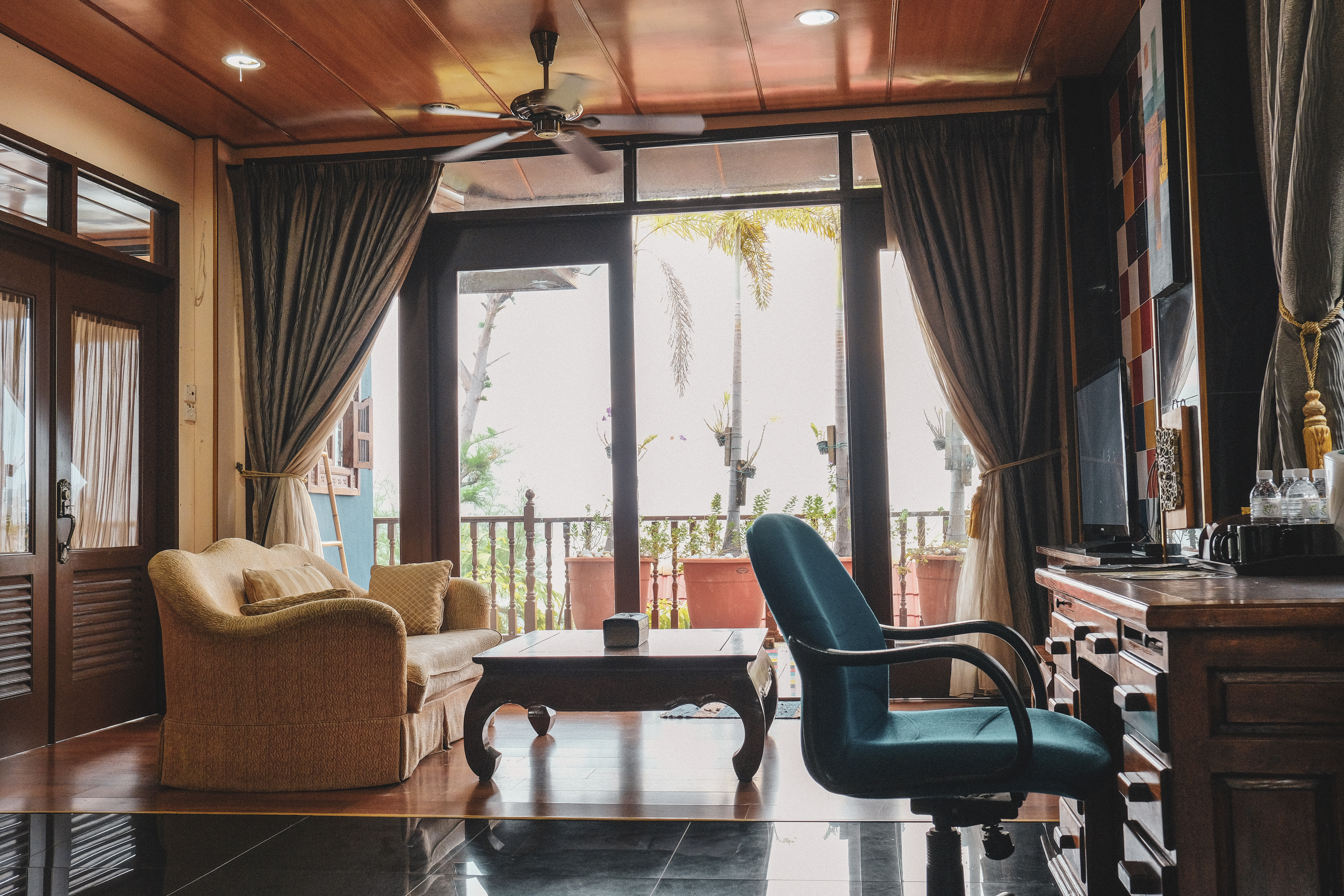 Substantial living room in the Royal Suite, with an expansive outlook of the Malacca Strait.