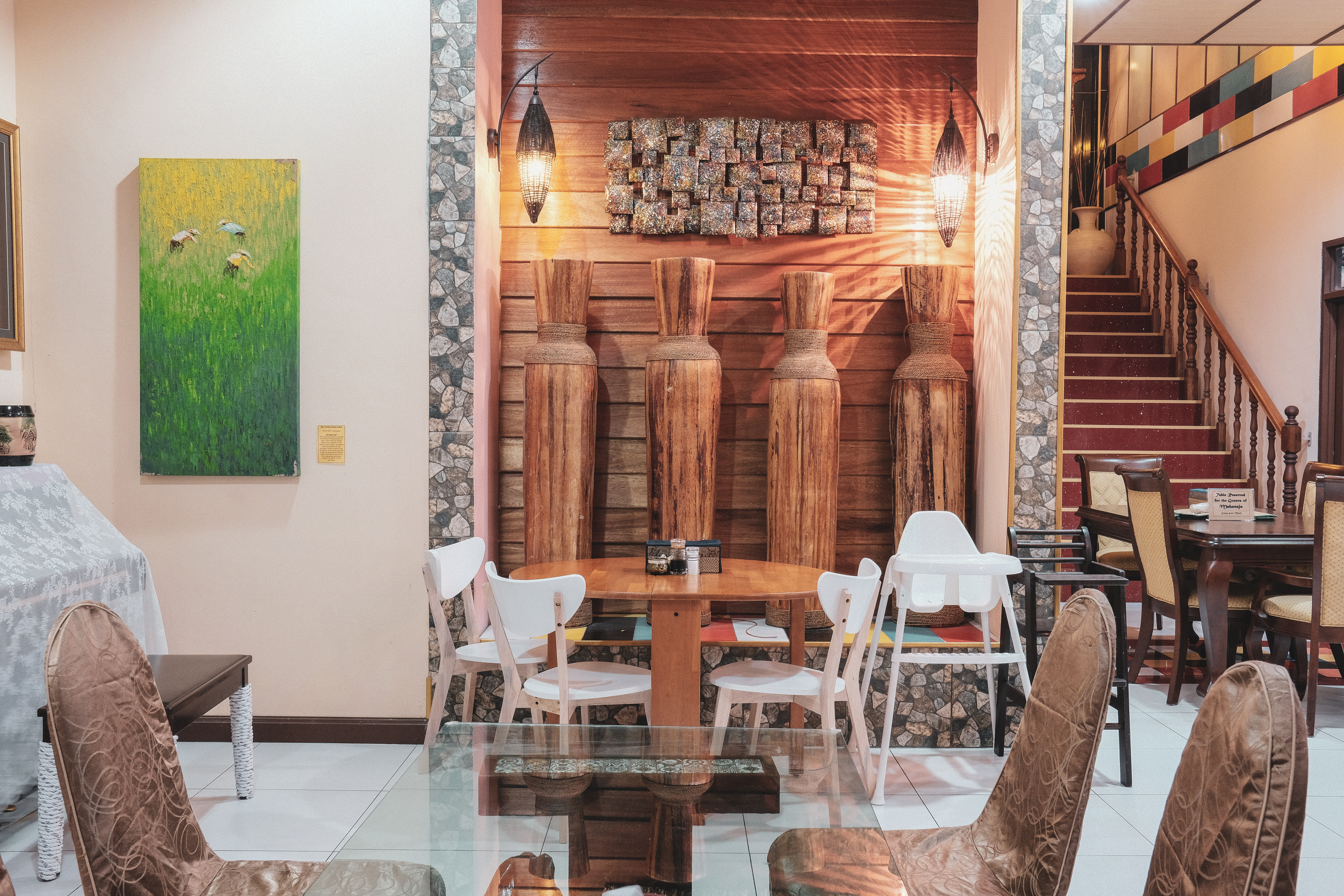 Slender, wooden vases, a collection of tropical-themed paintings and a smattering of colourful tiles add warmth and cheer to the dining hall, which used to be the Chews’ living room.
