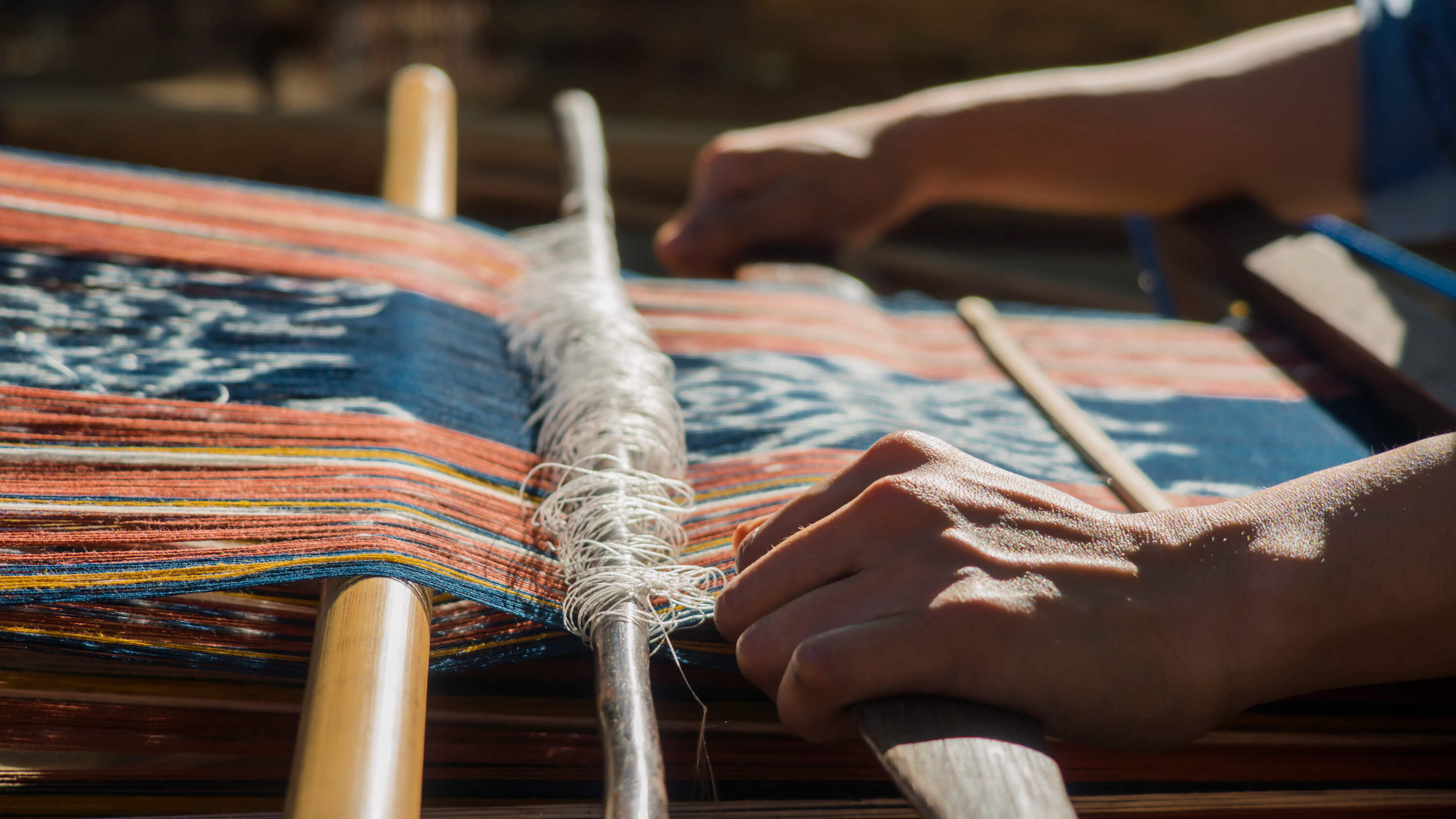 As the weft is fed through the warps, threads transform info fabric. Photo by Andra Fembriarto