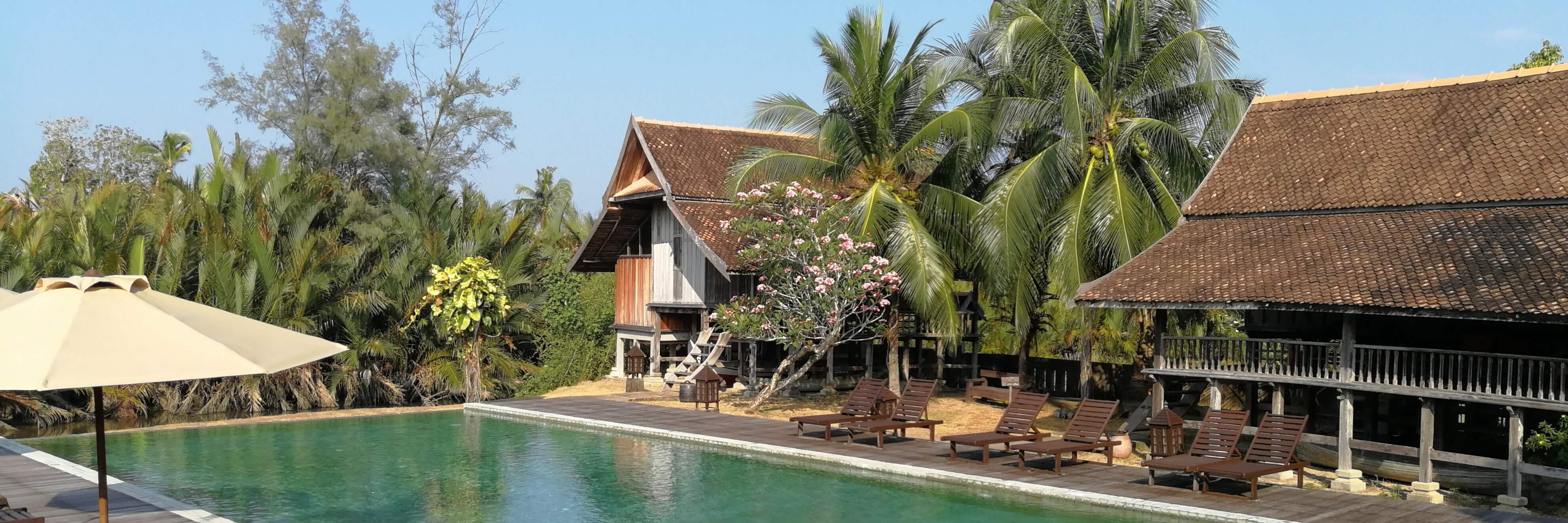 A swimming pool in a courtyard surrounding by restored classic Malay villas at Terrapuri Heritage Village