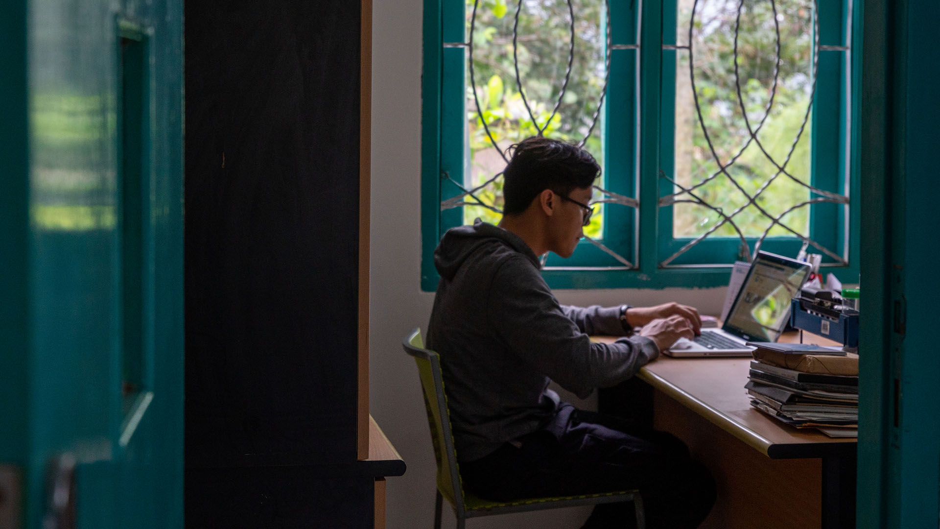 Agung working on his laptop