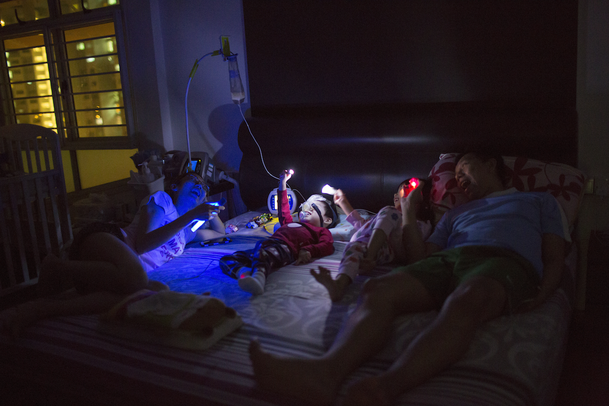 Family time includes playing with torches in the dark. When he sleeps, Caelen needs to wear a respiratory mask to ensure that he breathes properly through the night