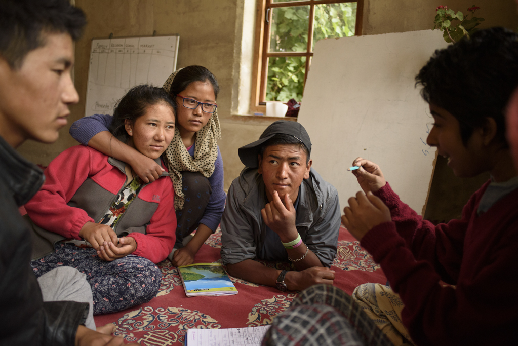 Sohini, a volunteer, moderates a discussion in conversation class. Students are encouraged to voice their opinions and discuss perspectives on various topics.