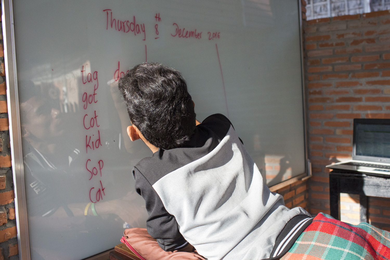 Sophanna preparing for class before his students arrive. Sophanna preparing for class before his students arrive.