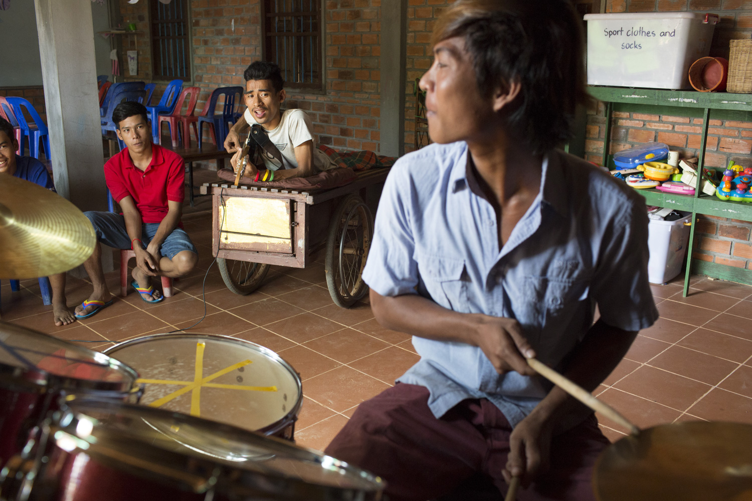 During the weekend, Sophanna teaches music to a group of young aspiring musicians.