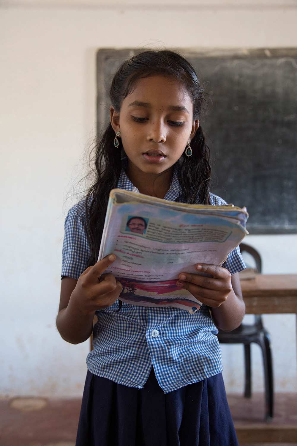 Preethi reads at the front of her class - a common practice at the school.