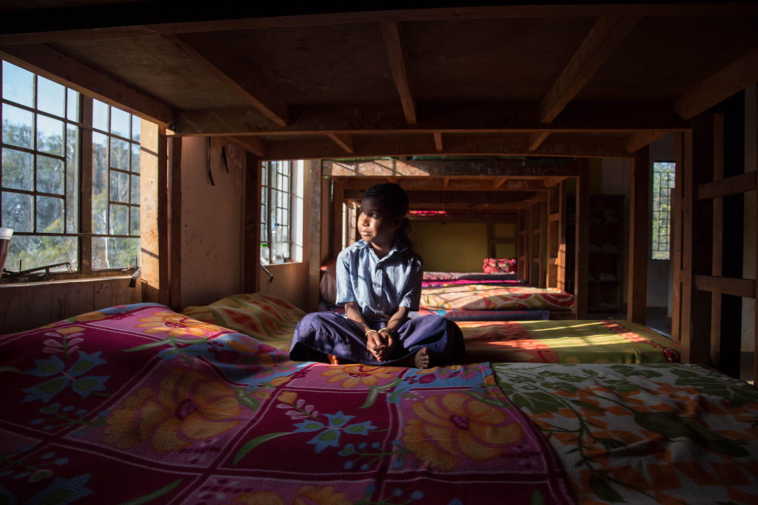 Janaki sits by the window at the girls’ dormitory. She could one day follow in the footsteps of her predecessors, a handful of whom are now doing university degrees. Janaki sits by the window at the girls’ dormitory. She could one day follow in the footsteps of her predecessors, a handful of whom are now doing university degrees.