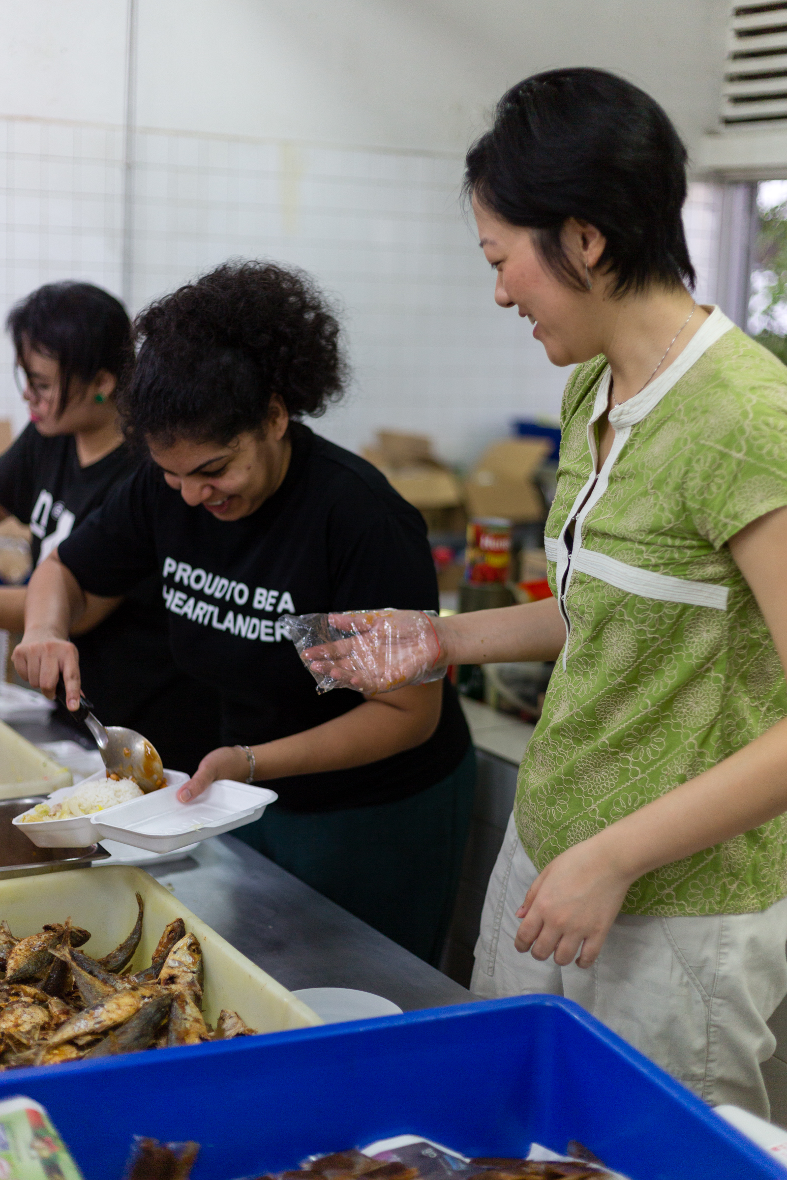 Noelle and Rebecca pack the cooked food into hundreds of containers, to be delivered to the needy