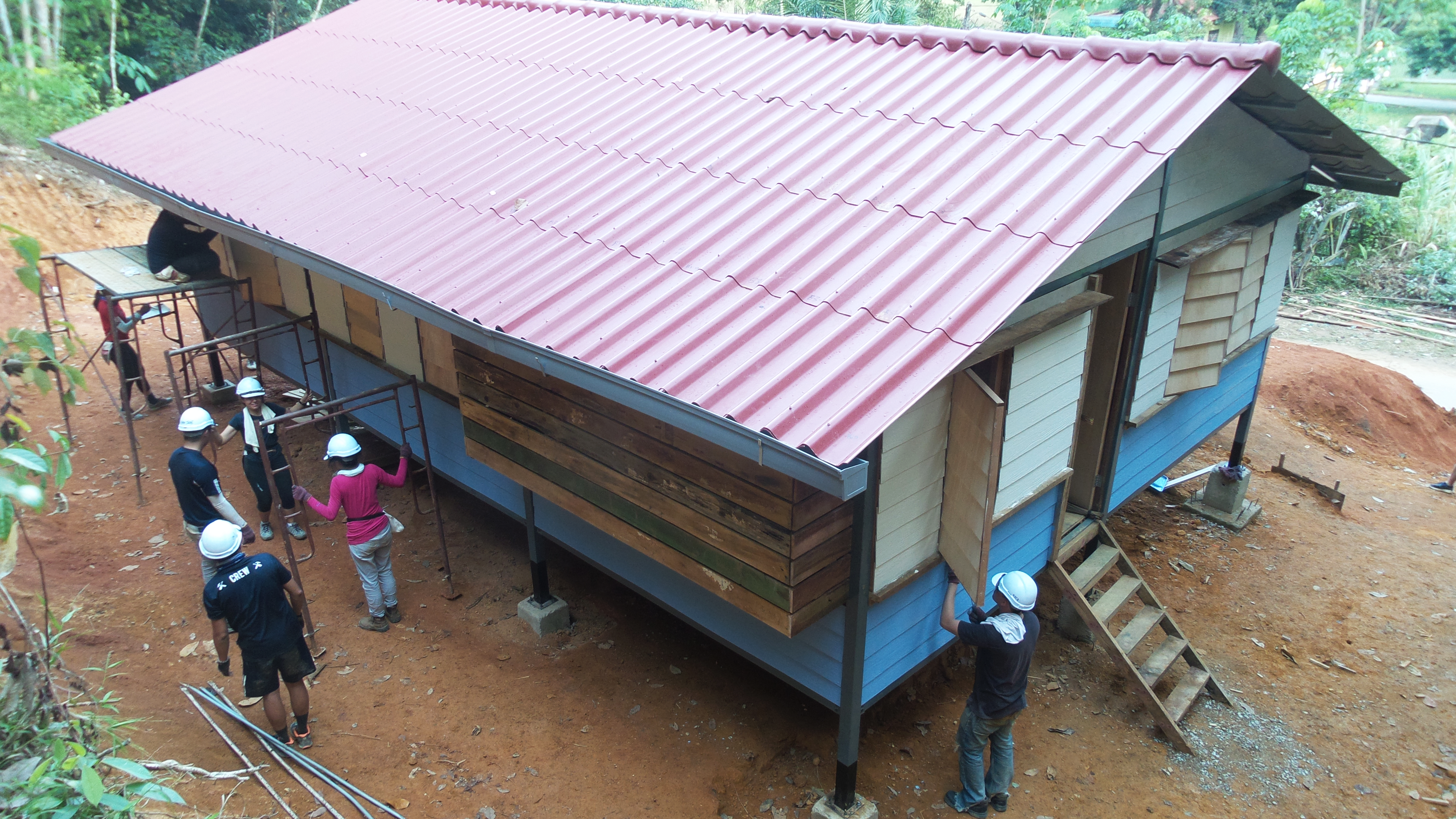 Volunteers build a home with the Orang Asli recipients