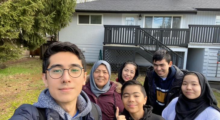 Abdullah and his family in front of their new home in Vancouver, Canada
