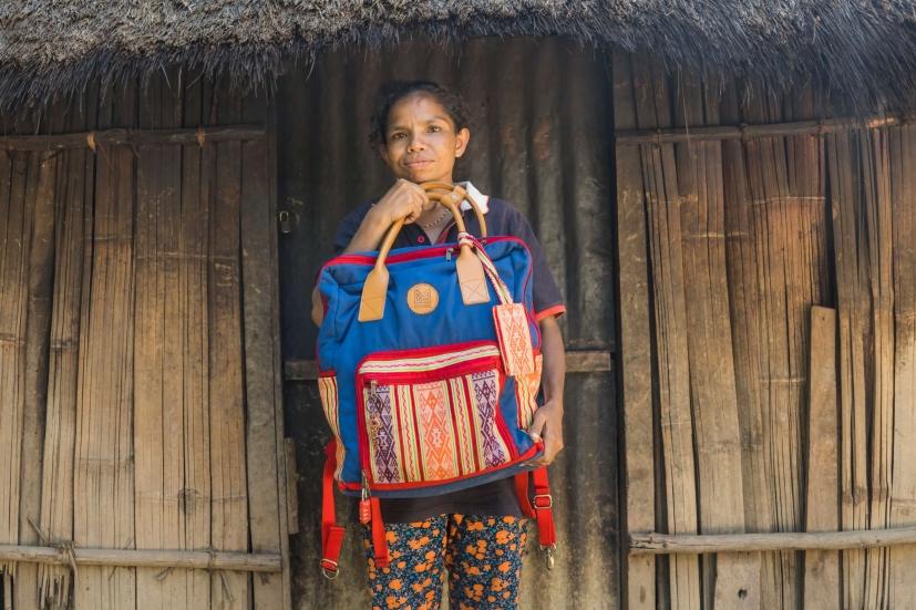 Amelia holds a tenun backpack from a Yogyakarta-based brand that partners with Lakoat.Kujawas to incorporate tenun into their pieces. The tenun is by Amelia.