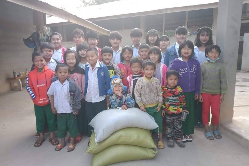  Kids in a GVH foster home receiving bags of rice. GVH provides 60 sacks of rice (or 3000kg) to about 350 kids on a monthly basis. Photo courtesy of GVH.