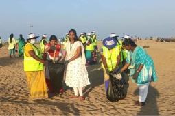 Picking litter along the beach 