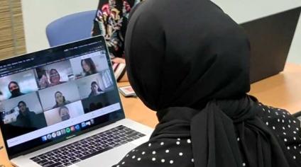 Lady looking at a video conferencing screen on her laptop