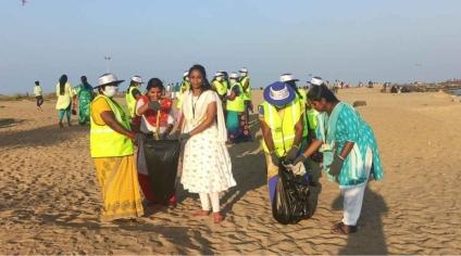 Picking litter along the beach 