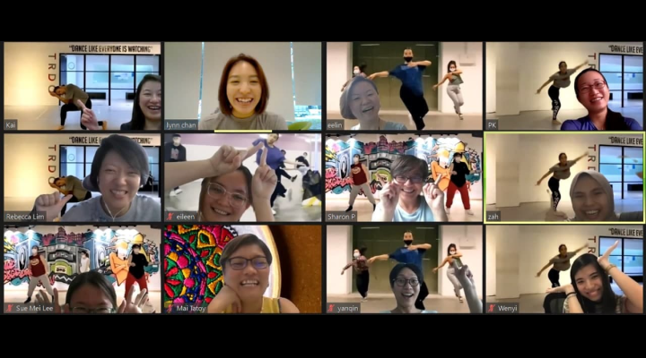 A virtual meeting with a girl dancing as background