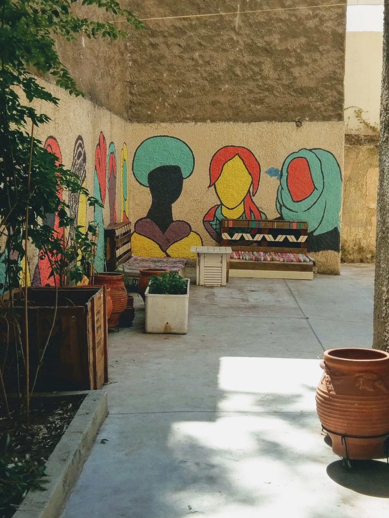 A colourful mural of women on wall at the Pomegranate Project, a shelter for women in Athens, Greece started by Action for Women to help refugee women safely integrate into Greek society. 